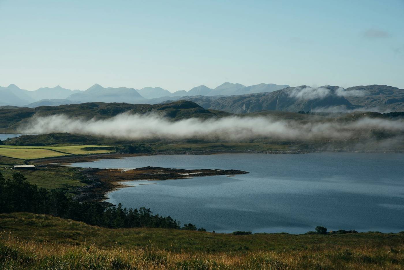 Mist lying over a Highland loch and hills